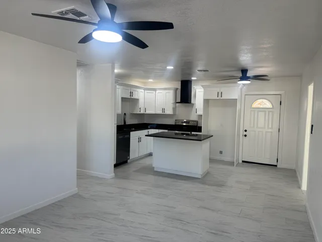 a view of kitchen appliances and cabinets