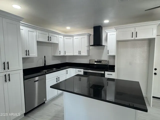 a kitchen with a sink and white cabinets