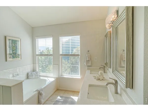 a bathroom with a bathtub sink and mirror