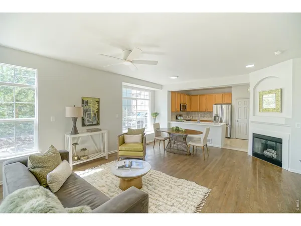 a living room with furniture wooden floor and a fireplace