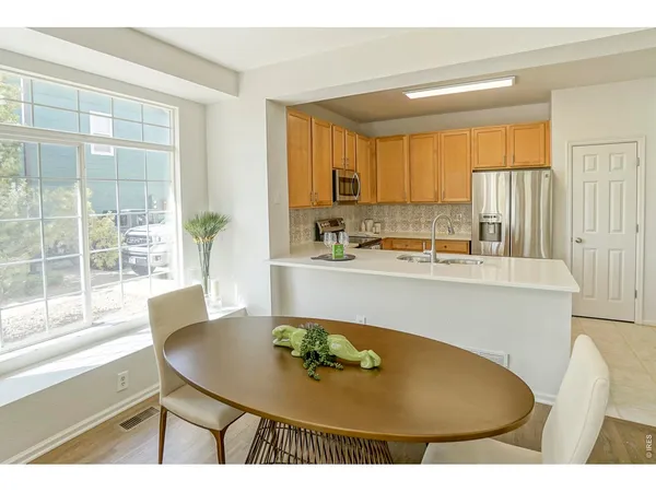 a kitchen with a table and chairs