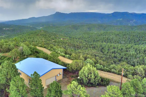 an aerial view of a house with a yard
