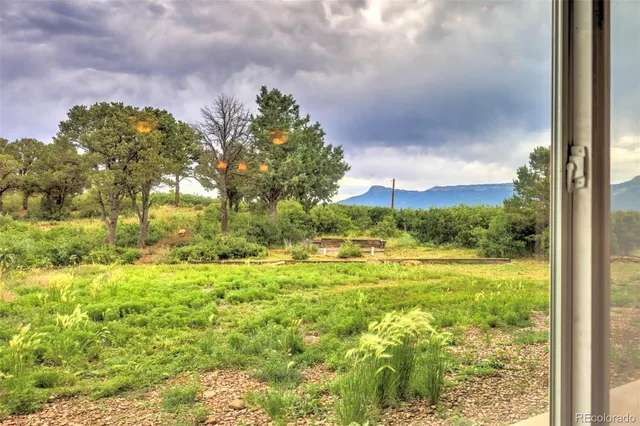 a bedroom with a bed and a flat tv screen on the dresser