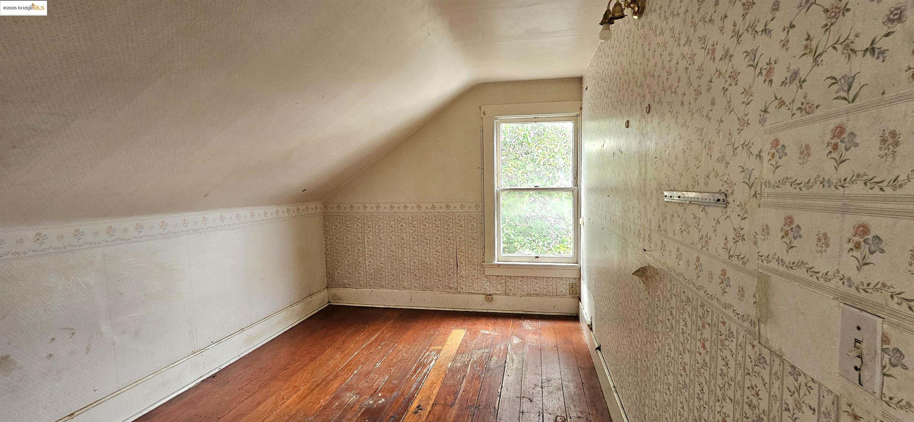 2308 Parker Street Berkeley, CA 94704 - Photo 3 of 17 wooden floor in an empty room with a window