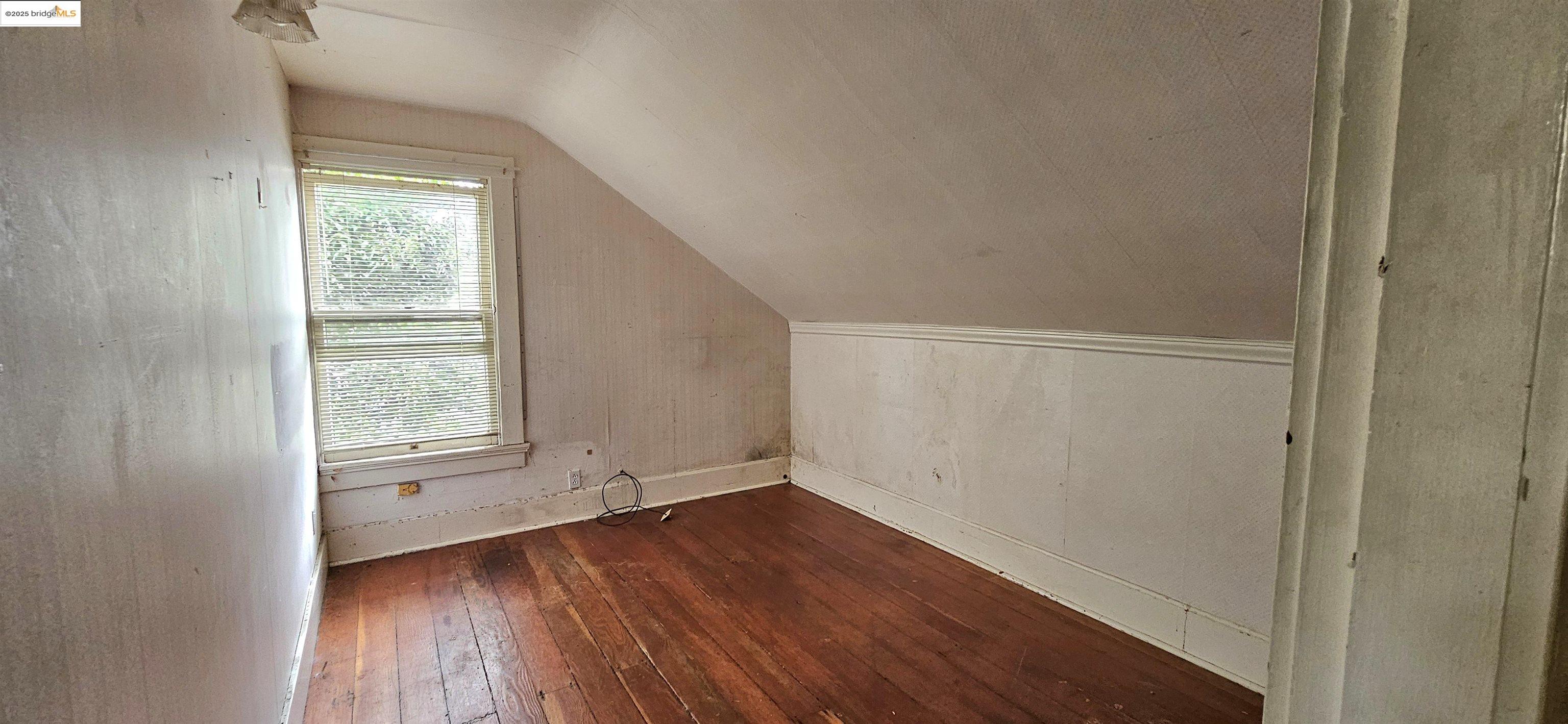 2308 Parker Street Berkeley, CA 94704 - Photo 5 of 17 an empty room with wooden floor and windows