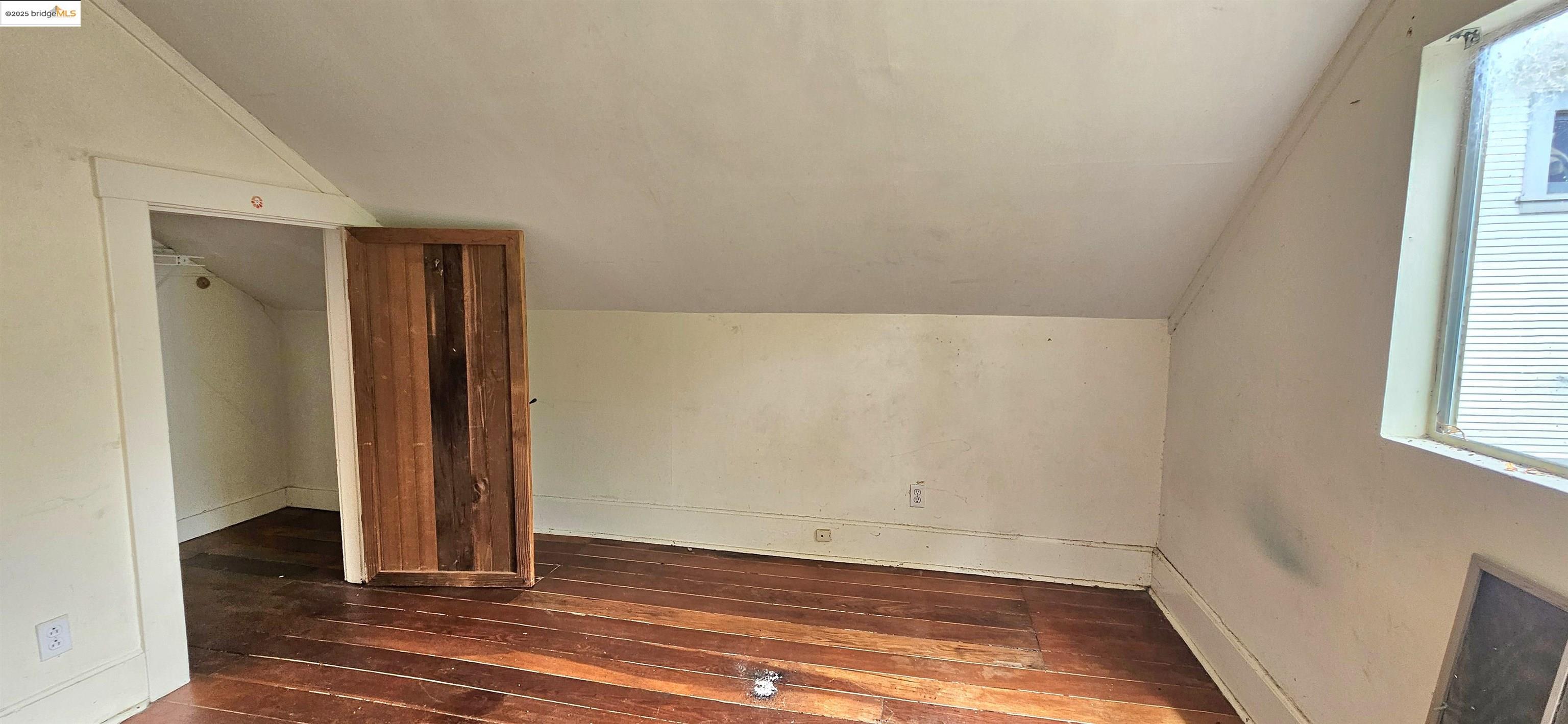 2308 Parker Street Berkeley, CA 94704 - Photo 8 of 17 an empty room with wooden floor and windows
