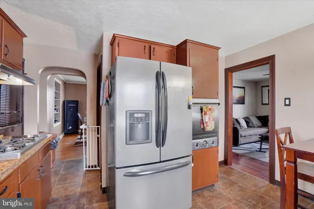 a kitchen with stainless steel appliances granite countertop a refrigerator and a sink