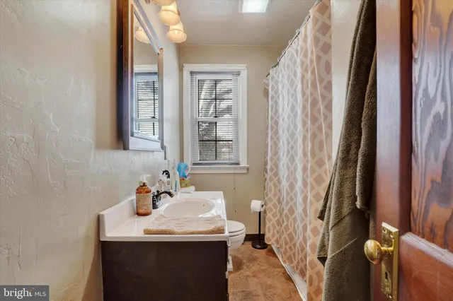 a bathroom with a sink a mirror and a shower