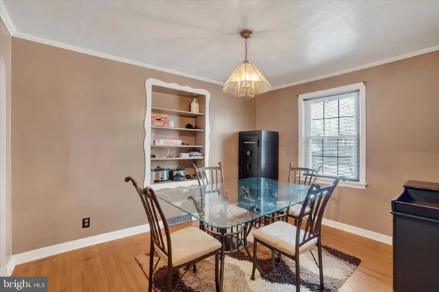 a view of a dining room with furniture wooden floor and chandelier