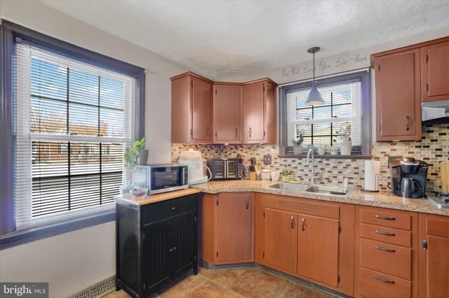 a kitchen with a sink a window and cabinets