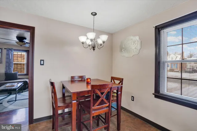 a view of a dining room with furniture a chandelier and wooden floor