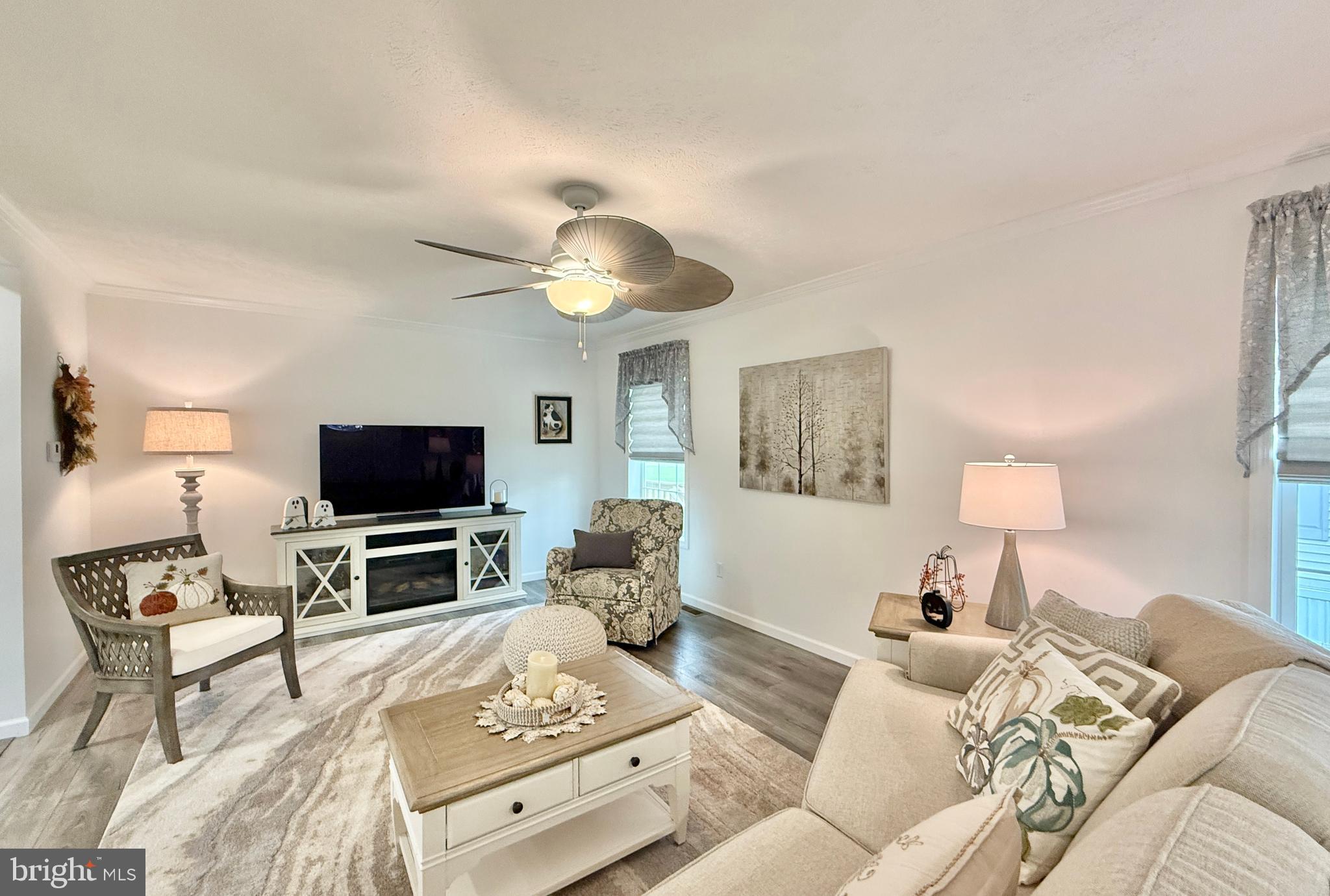 768 East Garden Road, Unit 7 Vineland, NJ 08360 - Photo 15 of 37 a living room with furniture a flat screen tv and a chandelier