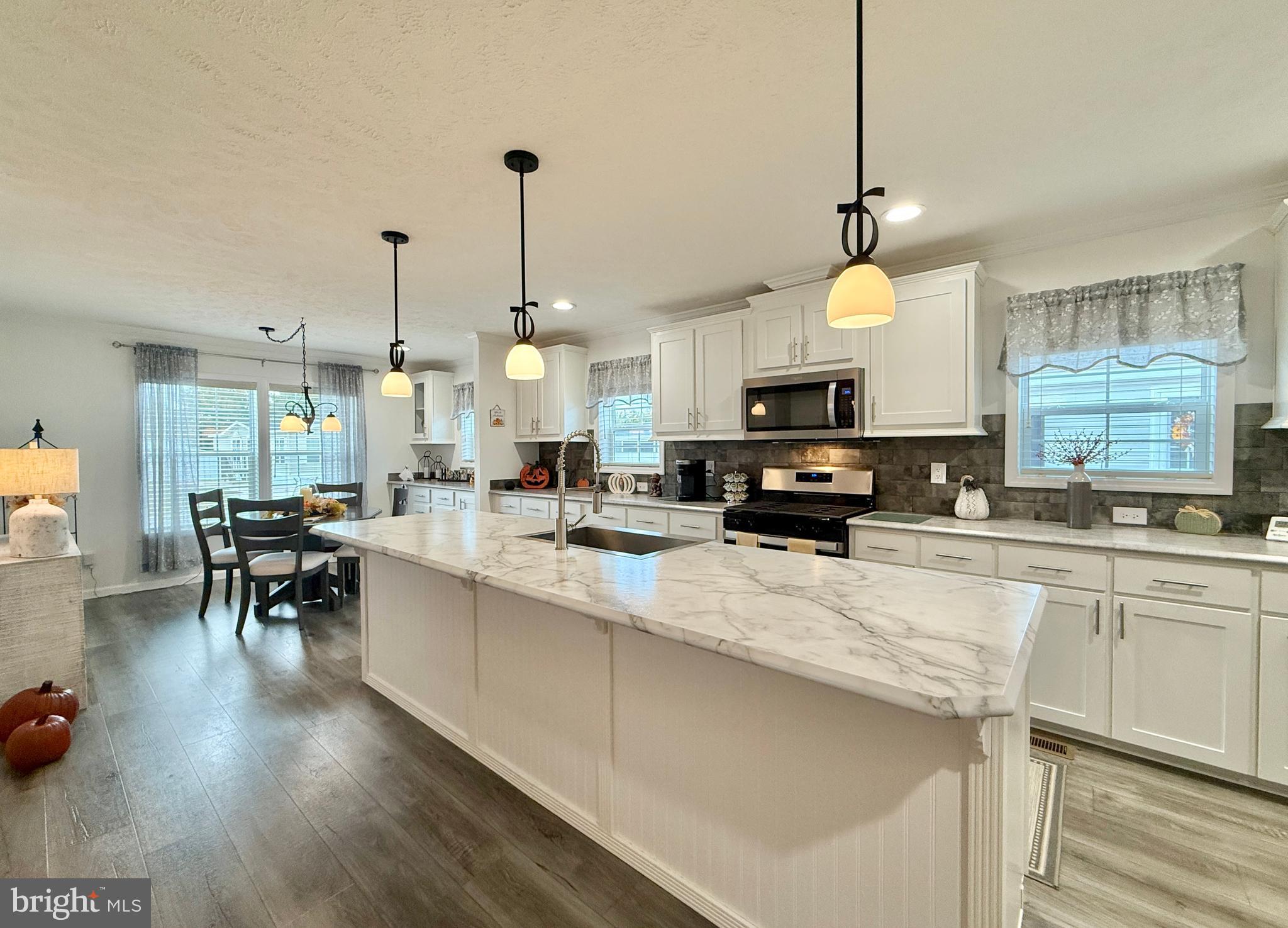 768 East Garden Road, Unit 7 Vineland, NJ 08360 - Photo 18 of 37 a kitchen with lots of counter space dining table and chairs