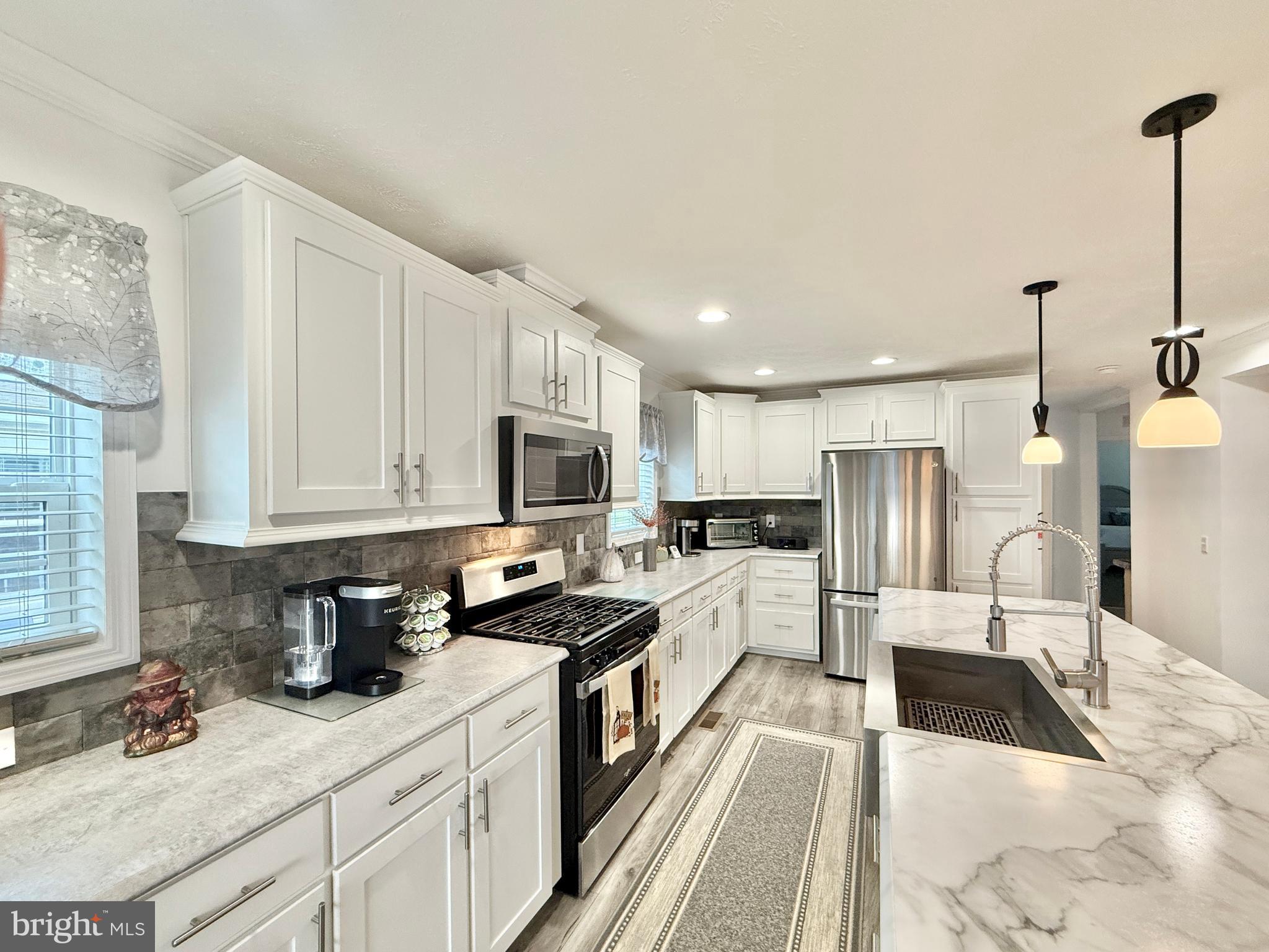 768 East Garden Road, Unit 7 Vineland, NJ 08360 - Photo 22 of 37 a kitchen with stainless steel appliances granite countertop a sink a stove and refrigerator