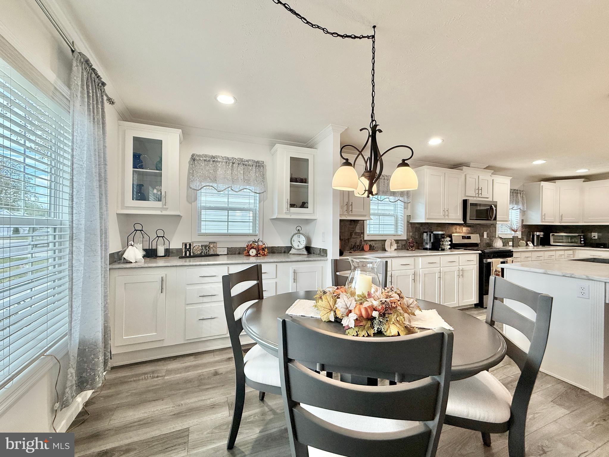 768 East Garden Road, Unit 7 Vineland, NJ 08360 - Photo 25 of 37 a kitchen with kitchen island granite countertop a sink a stove a dining table and chairs