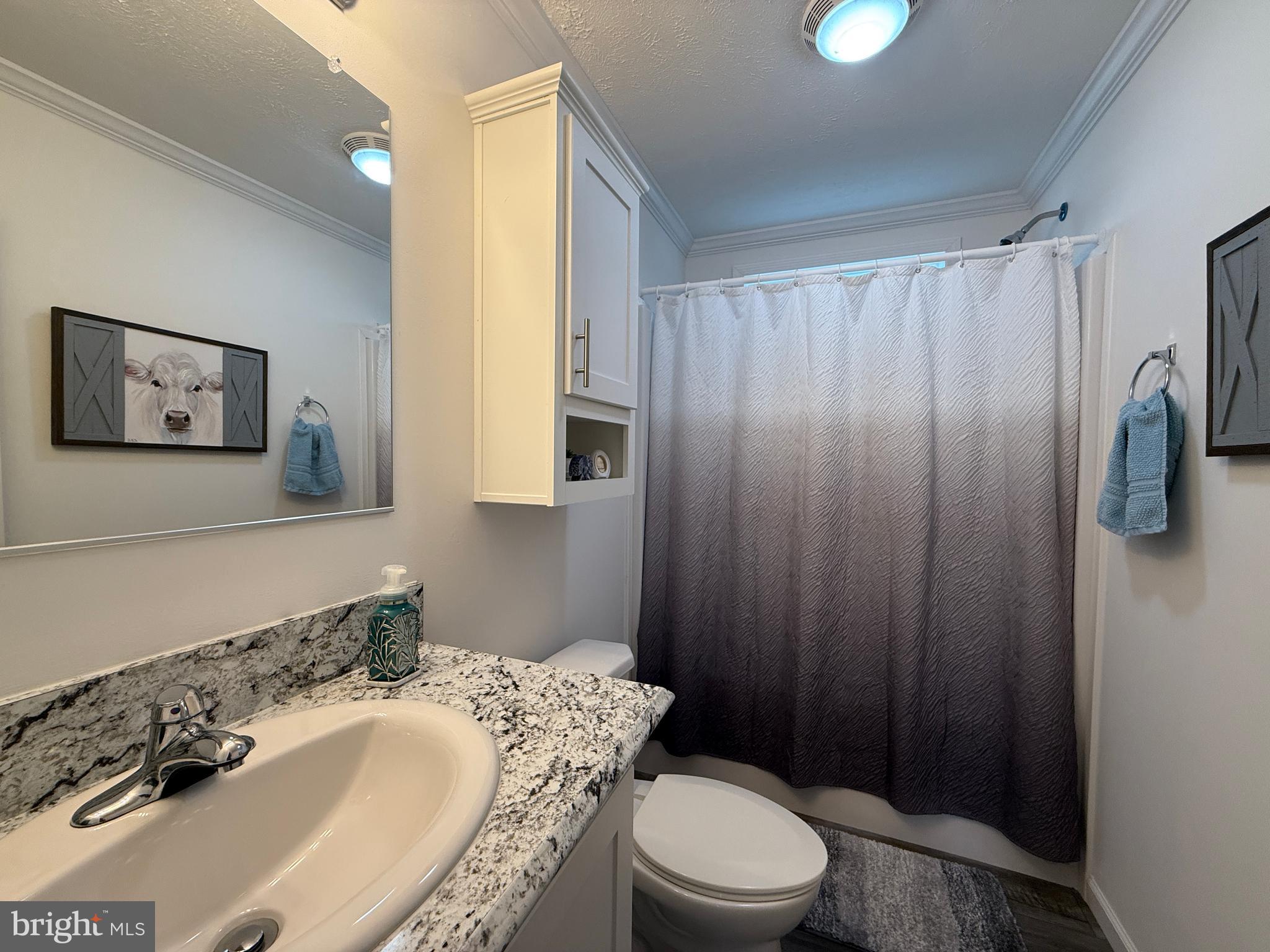 768 East Garden Road, Unit 7 Vineland, NJ 08360 - Photo 27 of 37 a bathroom with a sink a toilet and shower curtain