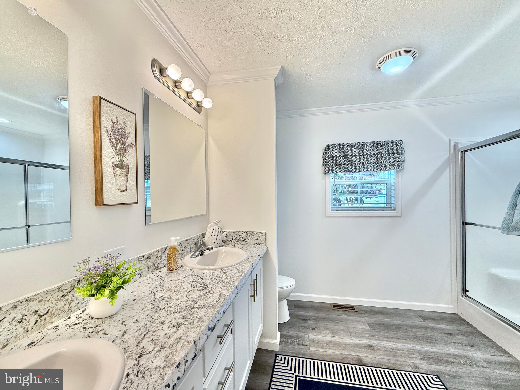 768 East Garden Road, Unit 7 Vineland, NJ 08360 - Photo 36 of 37 a bathroom with a granite countertop sink a toilet and mirror
