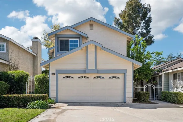 a view of a house with a garage and yard