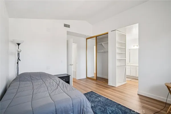a bedroom with a bed and wooden floor