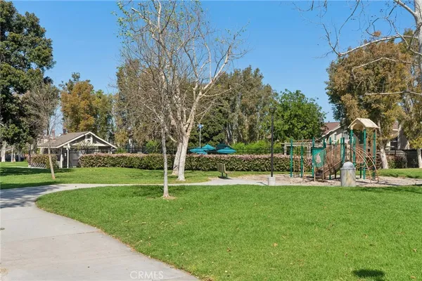 a view of a park with iron fence