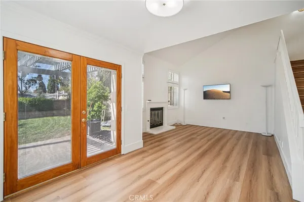 a view of a livingroom with wooden floor and a window