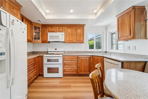 a kitchen with stainless steel appliances granite countertop a stove a sink dishwasher and a refrigerator