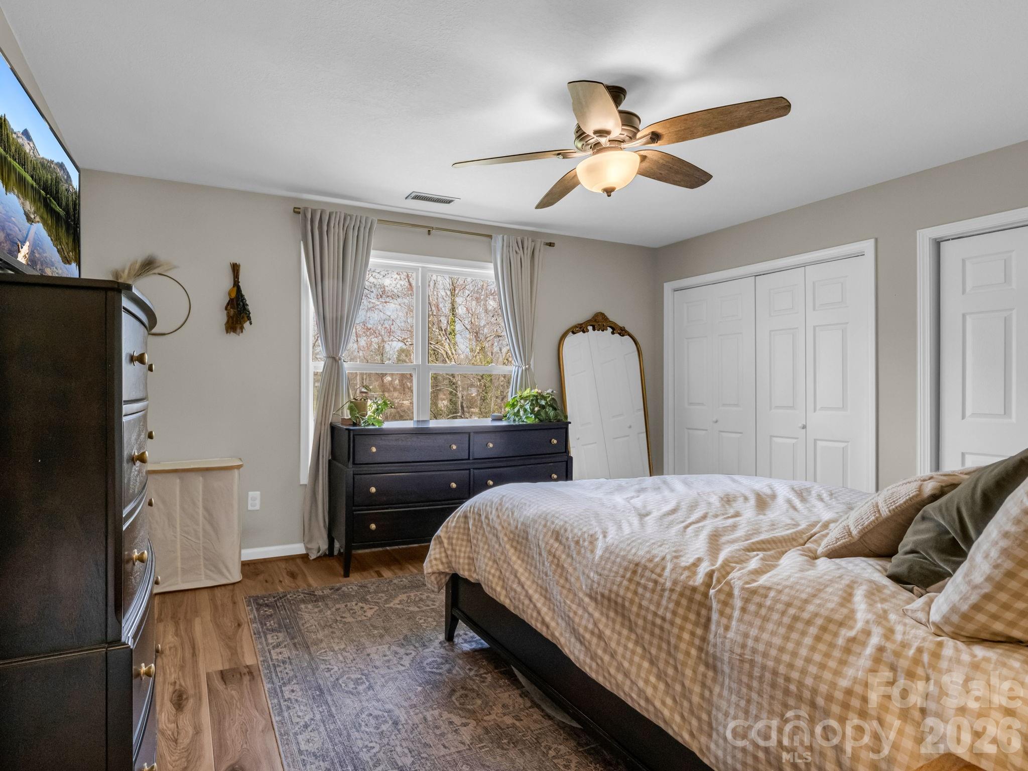 22 Macks Way Hendersonville, NC 28739 - Photo 20 of 42 a bedroom with a bed and a chandelier