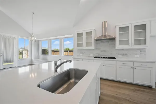a kitchen with granite countertop a sink and cabinets