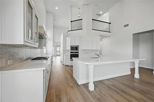 a kitchen with stainless steel appliances a white stove top oven and a sink