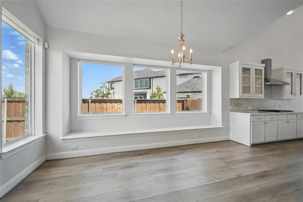 a view of an empty room with a kitchen
