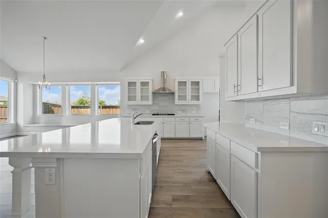 a kitchen with stainless steel appliances granite countertop a sink and cabinets
