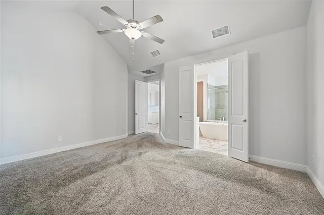 a view of a big room with chandelier fan and windows