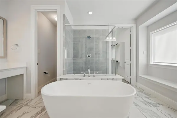 a white bath tub sitting next to a white sink