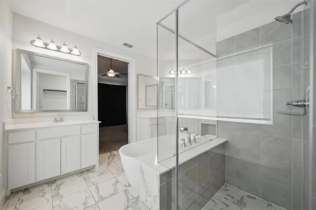 a bathroom with a sink vanity and mirror