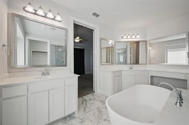 a bathroom with a sink vanity and mirror