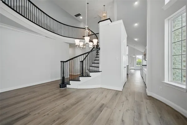 a view of entryway and hall with wooden floor