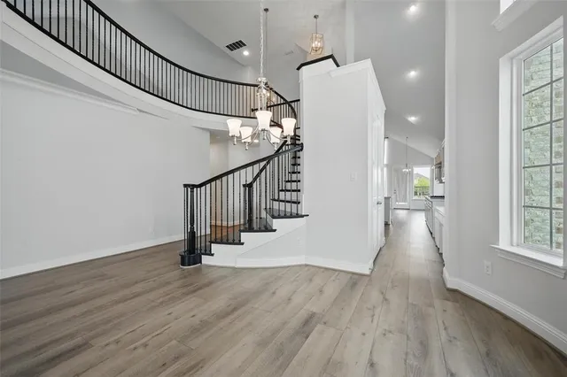 a view of entryway and hall with wooden floor