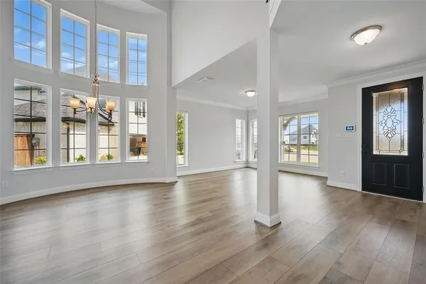 a view of an room with wooden floor and windows