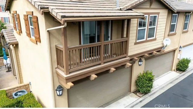 a view of a house with a window and wooden fence