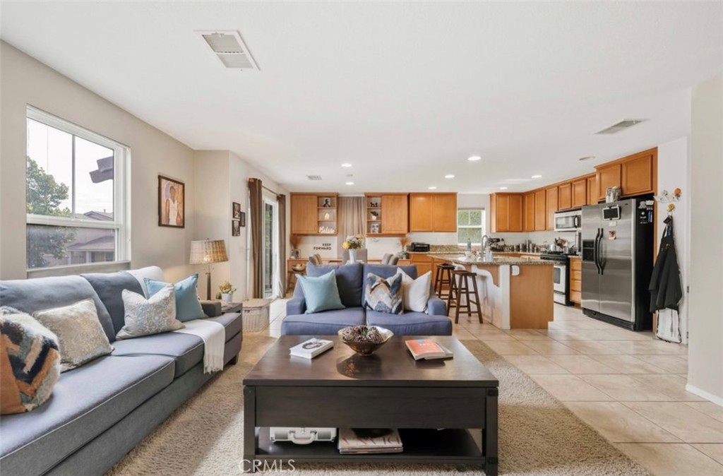 10326 Sparkling Drive, Unit 1 Rancho Cucamonga, CA 91730 - Photo 12 of 34 a living room with furniture kitchen and a table