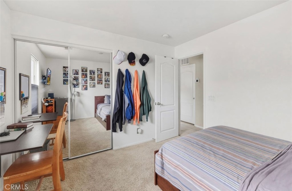 10326 Sparkling Drive, Unit 1 Rancho Cucamonga, CA 91730 - Photo 17 of 34 a bedroom with a bed and a walk in closet