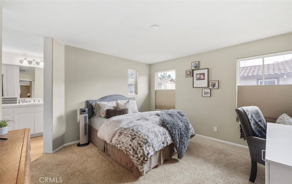 10326 Sparkling Drive, Unit 1 Rancho Cucamonga, CA 91730 - Photo 18 of 34 a bedroom with two beds and a chair