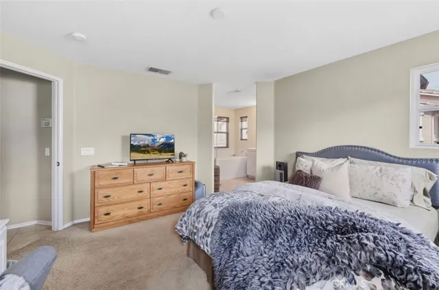 a bedroom with a bed and a dresser