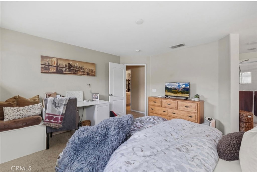 10326 Sparkling Drive, Unit 1 Rancho Cucamonga, CA 91730 - Photo 20 of 34 a bedroom with a bed and furniture