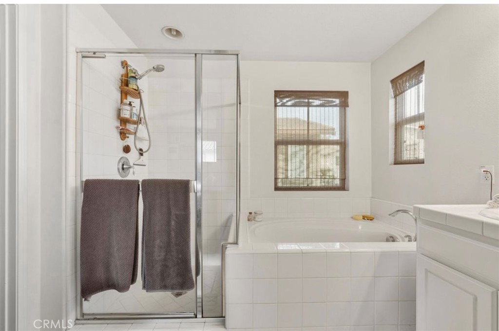 10326 Sparkling Drive, Unit 1 Rancho Cucamonga, CA 91730 - Photo 22 of 34 a bathroom with a bathtub and a shower