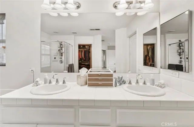 a bathroom with a sink double vanity and a mirror