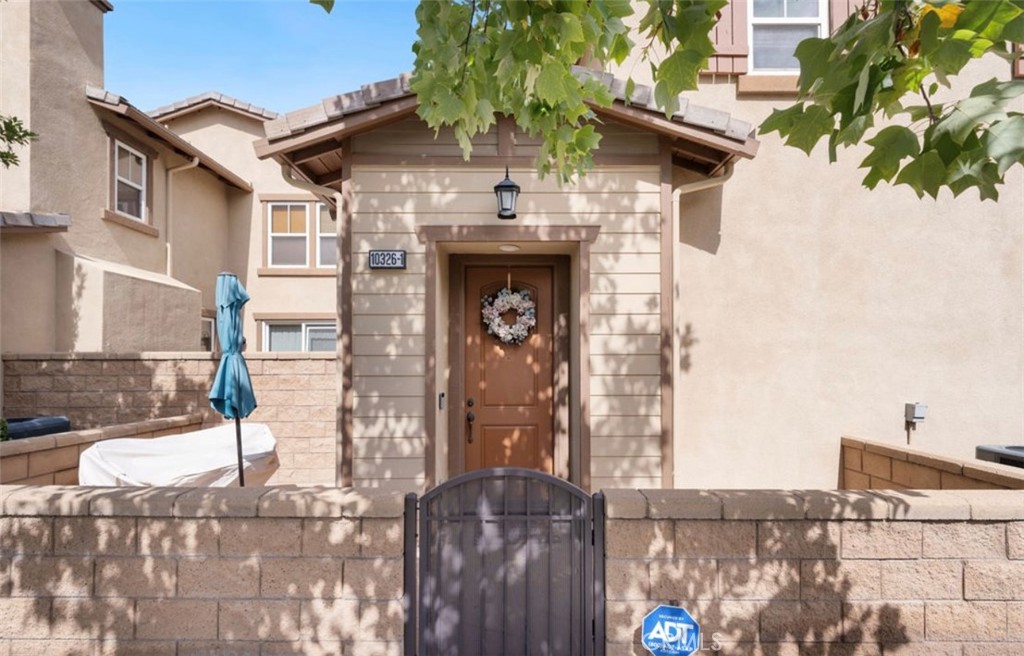 10326 Sparkling Drive, Unit 1 Rancho Cucamonga, CA 91730 - Photo 30 of 34 a front view of a house with garden