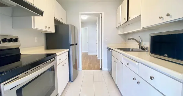 a kitchen with granite countertop cabinets stainless steel appliances and a counter space