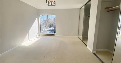 a view of empty room with a fireplace