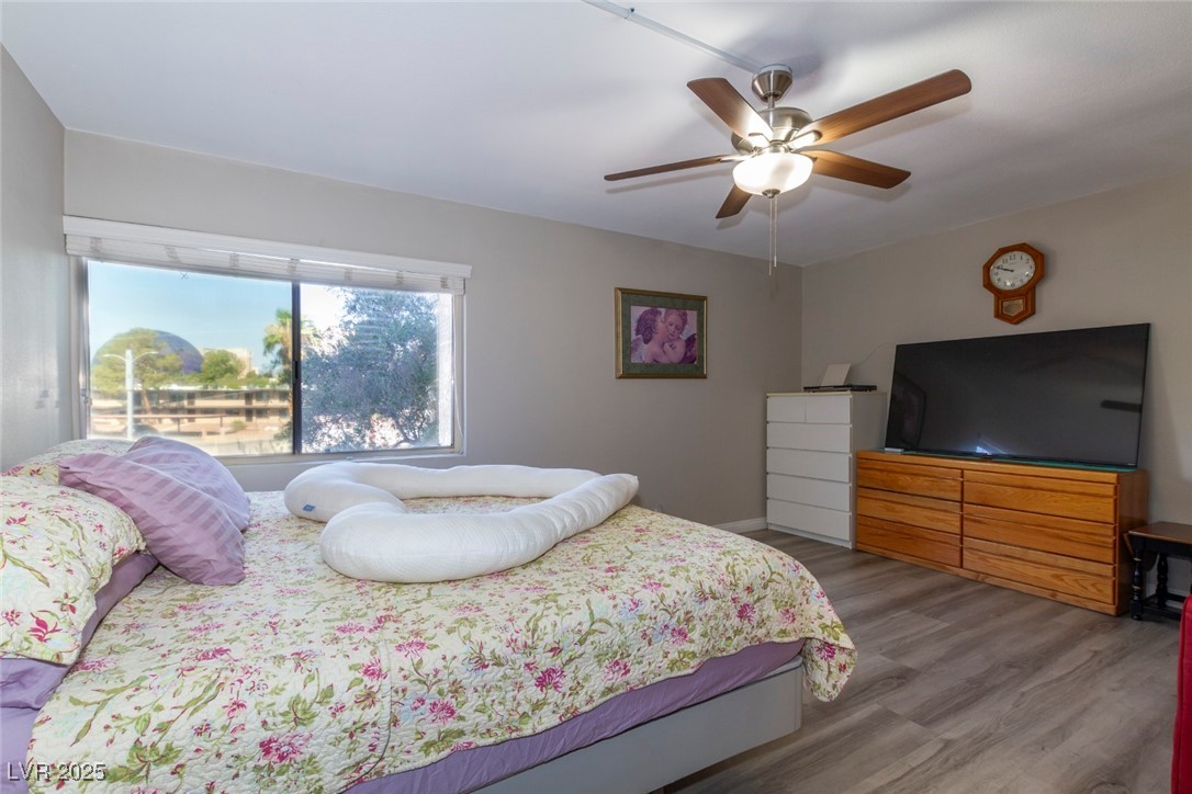 730 South Royal Crest Circle, Unit 421 Las Vegas, NV 89169 - Photo 11 of 21 Bedroom featuring wood finished floors and ceiling